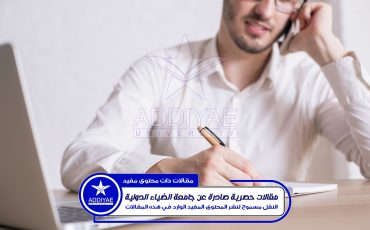 Young businessman talking on phone and working on project at wooden desk with notepad and laptop